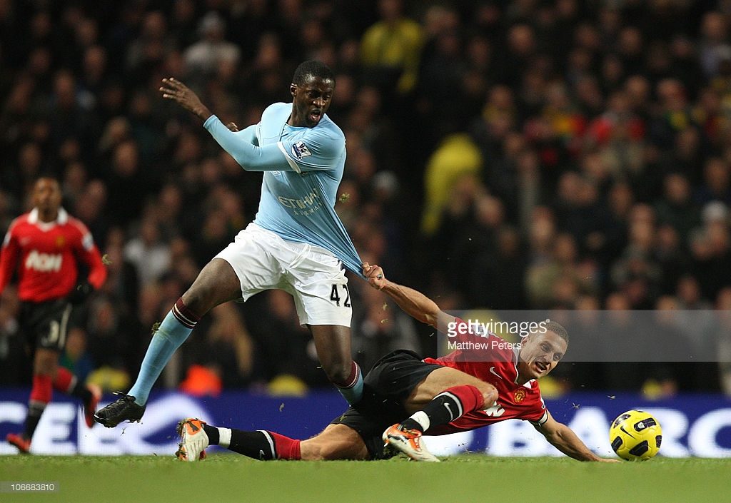 Nemanja Vidic of Manchester United clashes with Yaya Toure of Manchester City